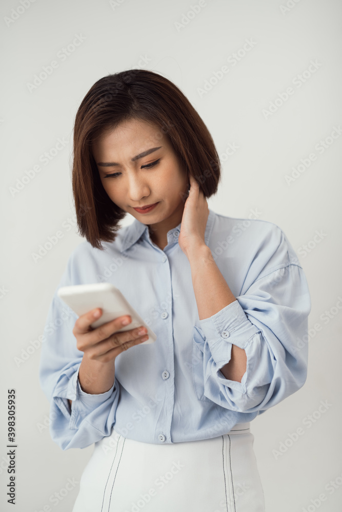 worried pretty asian girl reading urgent text message via smart worried pretty asian girl reading urgent text message via smart
