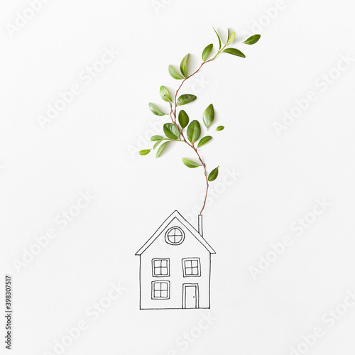 Sketch of house with branch of green leaves. photo