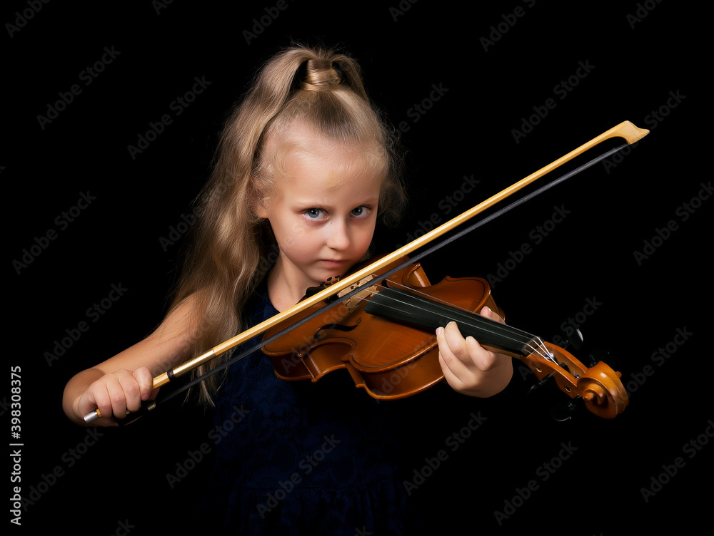 Young violinist with piercing gaze isolated on black background Young violinist with piercing gaze isolated on black background
