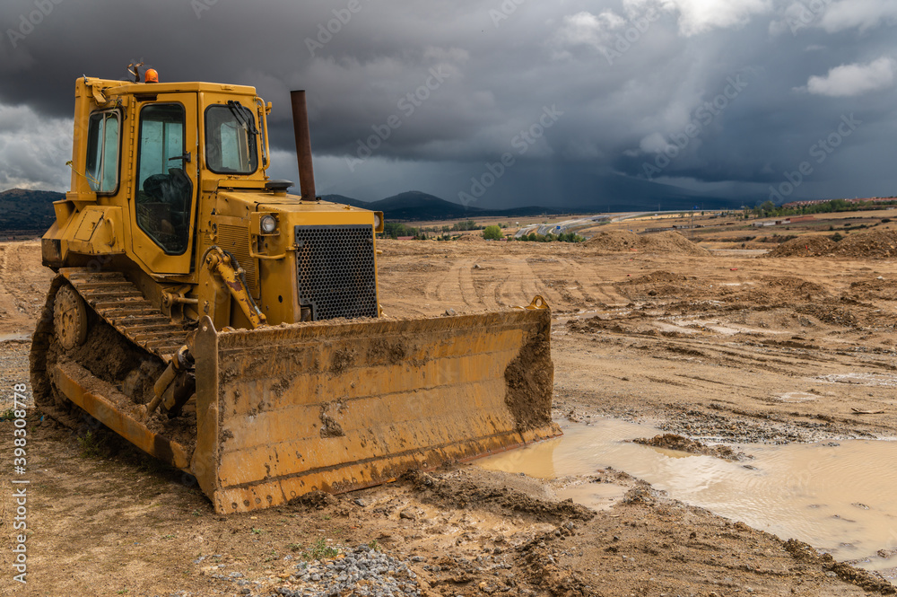 Excavator at a construction site, performing earth moving work Excavator at a construction site, performing earth moving work