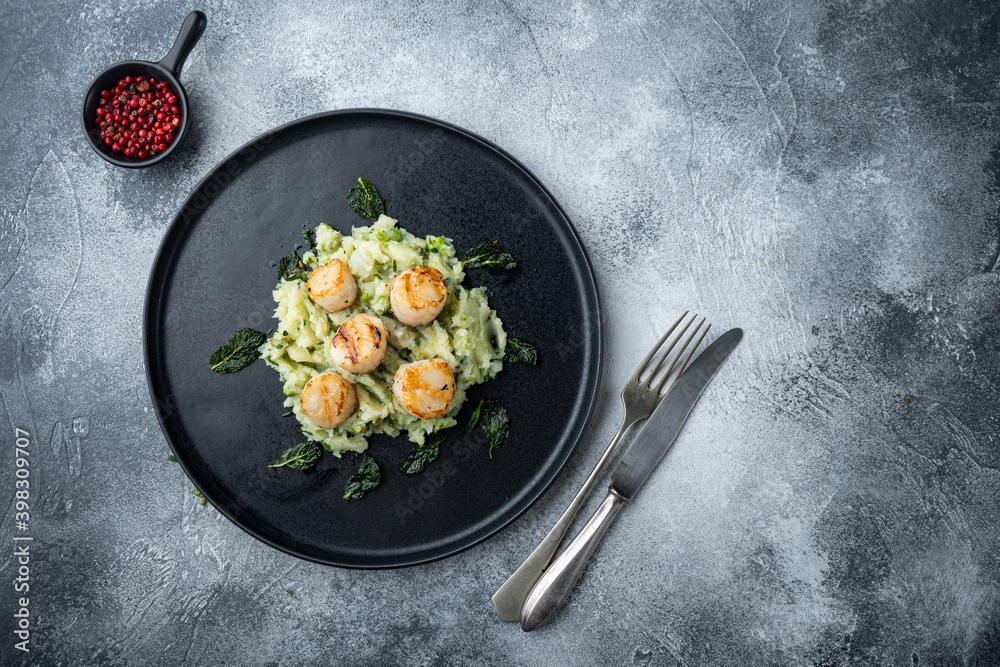 Grilled scallops with mashed potatoe, top view, on grey background  with copy space