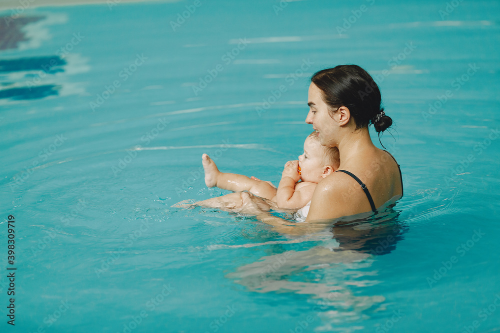 Little cute baby boy. Mother with son. Family playing in a water. Little cute baby boy. Mother with son. Family playing in a water.