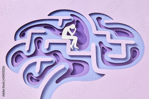 Handmade paper thinker inside papercraft structure of human brain.
