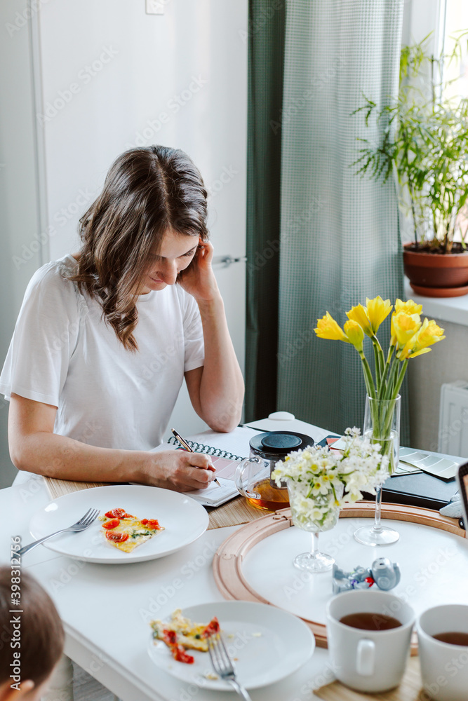 Female working while breakfast, staying at home while isolation Female working while breakfast, staying at home while isolation
