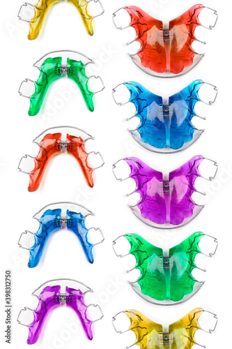 Vertical pattern of children's orthodontic appliances in bright and fun colours on white background. Concept of oral health in childhood