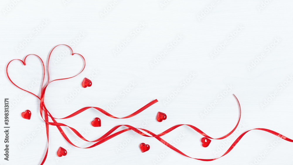 Two red hearts made from ribbon top view on white wooden background. Two red hearts made from ribbon top view on white wooden background.