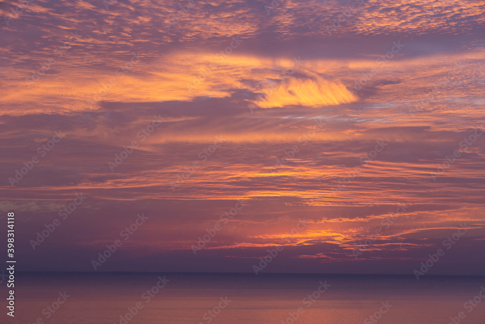 cirrus clouds at sunset over the sea