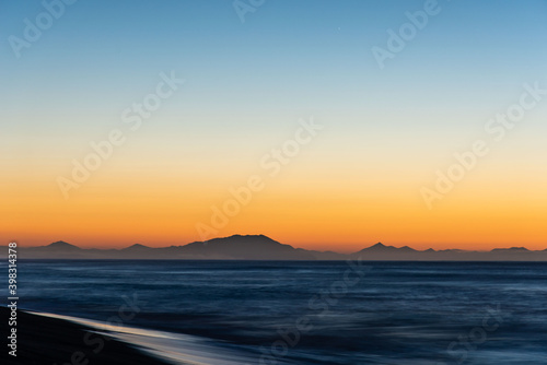 Sunrise scenery with soft waves of Khalaktyrsky Beach Kamchatka Peninsula, Russia. photo
