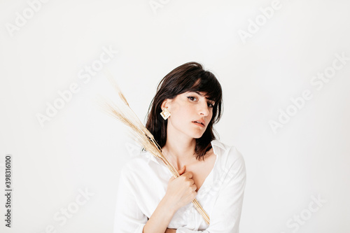 portrait of brunette young woman posing in studio with natural light