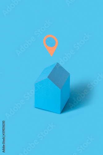 Blue colored papercraft house with location sign.