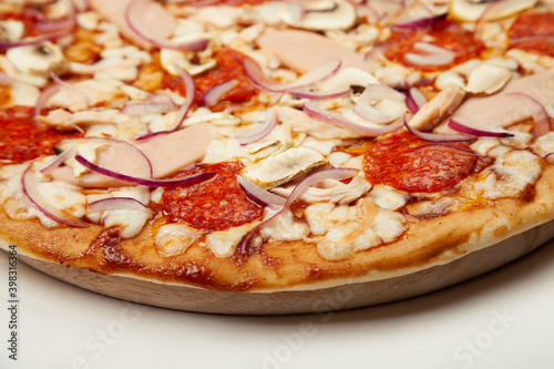 Delicious pizza BBQ sauce, mozzarella cheese, ham, pepperoni, smoked chicken, mushrooms, red onion. Close-up. Restaurant flyer and poster.