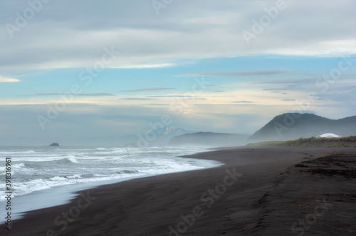 Amazing ocean coastline of Beach Khalaktyrsky with black volcanic sand in Kamchatka, Russia photo
