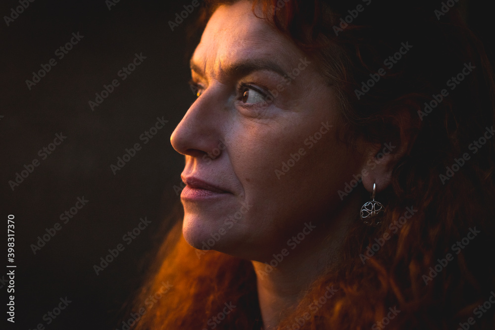 Portrait of middle aged woman with vitiligo and orange hair