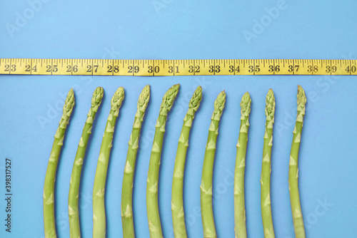 Natural asparagus spears and measuring tape. photo