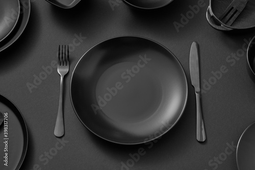 Black ceramic plate served fork and knife.