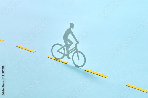 Handmade biker rides by road marking. photo