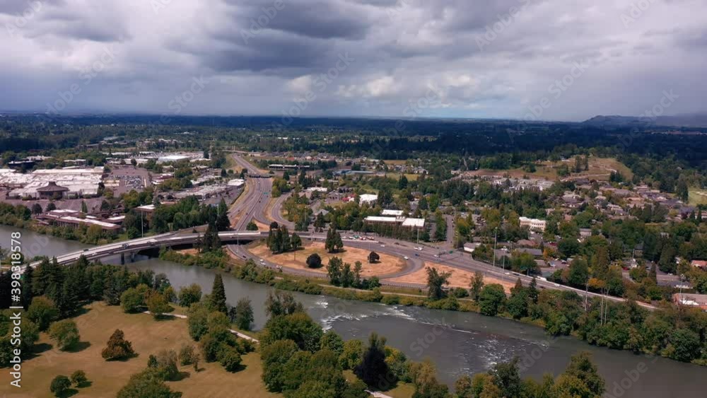 Vehicles Driving In Oregon Route 126 With Interstate 105 Over Willamette River Near City Of Eugene From Kiwanis Park In Oregon. - aerial Vehicles Driving In Oregon Route 126 With Interstate 105 Over Willamette River Near City Of Eugene From Kiwanis Park In Oregon. - aerial