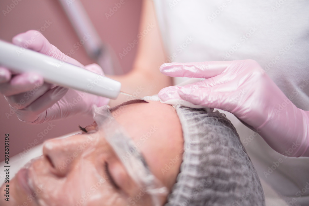 Beautician makes facial cleansing for a girl in the salon
Beautician makes facial cleansing for a girl in the salon