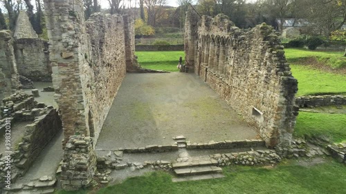 Basingwerk abbey landmark medieval abandoned Welsh ruins Aerial view inside pull away photo