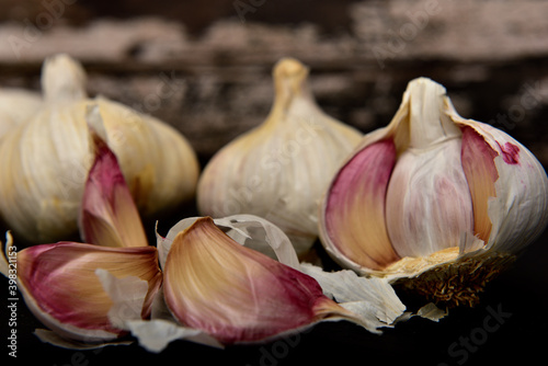 Organic white garlic on a black slate plate