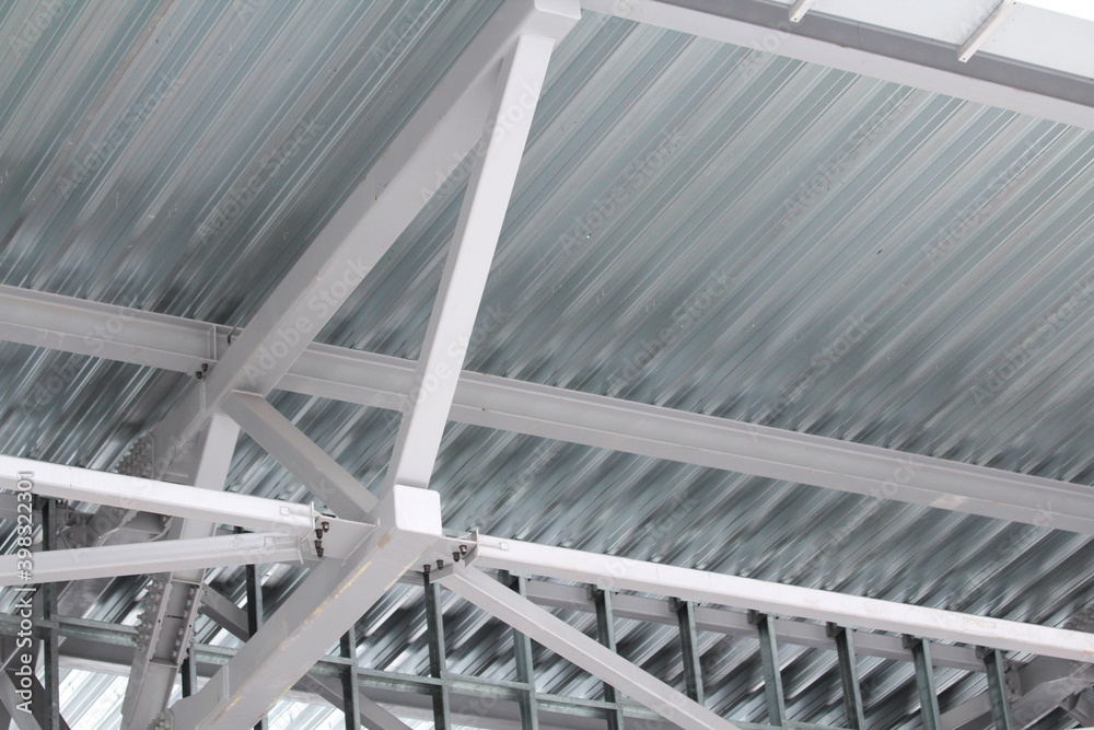 An old steel metal farm. structure of metal structure of frame-type industrial building. Lightweight metal frame construction. An old steel metal farm. structure of metal structure of frame-type industrial building. Lightweight metal frame construction.