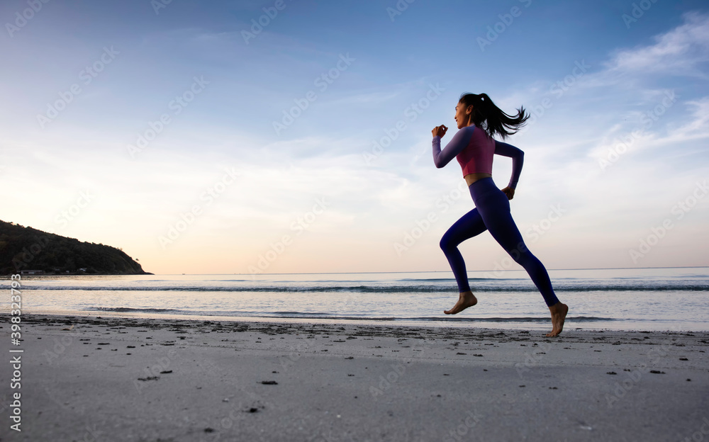 Healthy and port lifestyle of woman running along the beach, runner Woman Running on The Beach Healthy and port lifestyle of woman running along the beach, runner Woman Running on The Beach