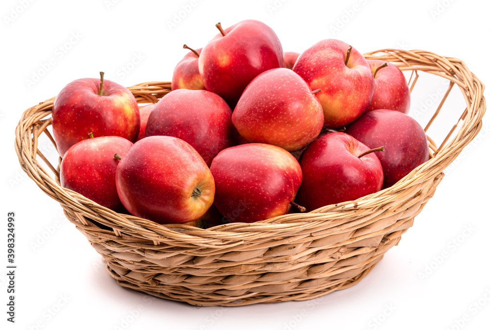 Red apples in a wicker basket. Isolate on white background Red apples in a wicker basket. Isolate on white background