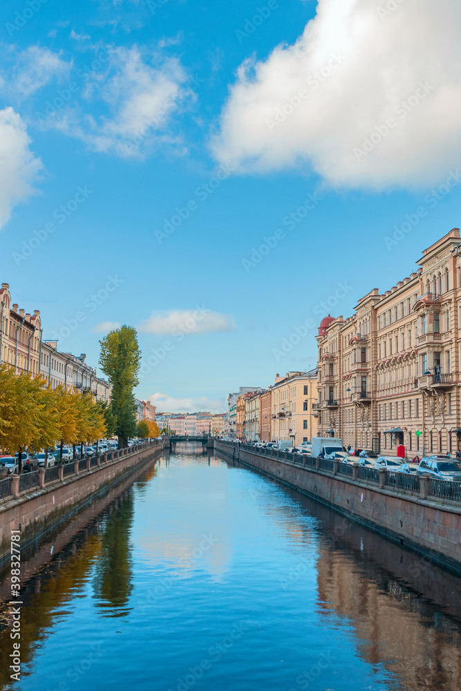 view of the Fontanka canal with beautiful houses on the shore against the blue sky