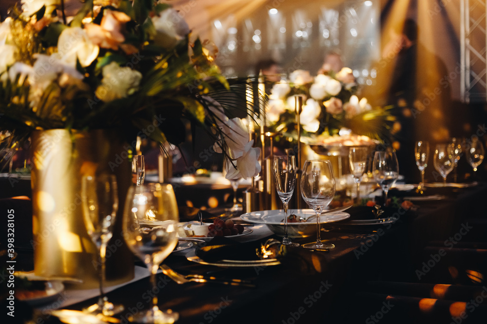 tableware Glasses, flower fork, knife served for dinner in restaurant with cozy interior tableware Glasses, flower fork, knife served for dinner in restaurant with cozy interior