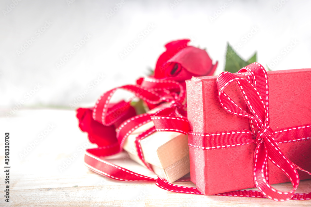 Valentines Day concept, Red Roses and Gift Boxes with Festive Ribbon and Heart Decor on White wooden table background copy space. Romantic floral background. Valentines Day concept, Red Roses and Gift Boxes with Festive Ribbon and Heart Decor on White wooden table background copy space. Romantic floral background.