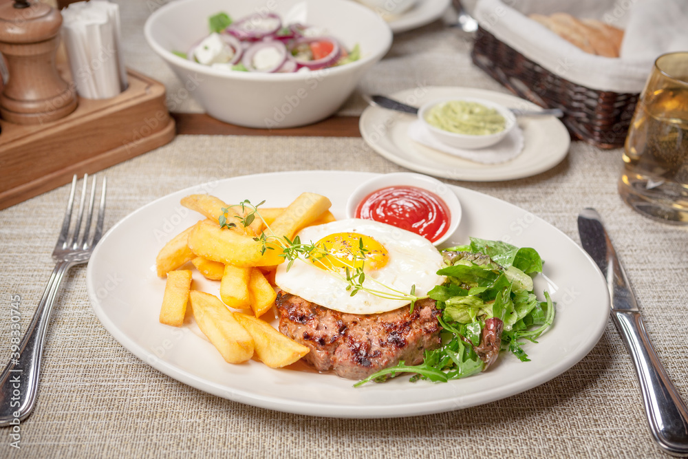 Beef cutlet, fried egg and fries Beef cutlet, fried egg and fries