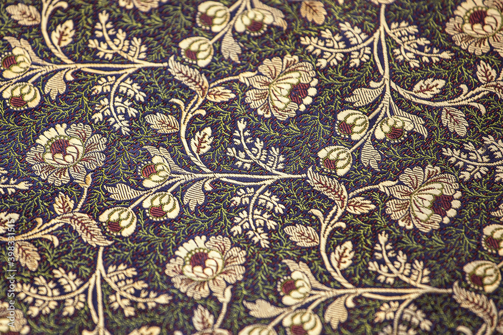 Jacquard fabric, floral motif. Close-up of elegant and splendid silk fabric with a floral ornament.