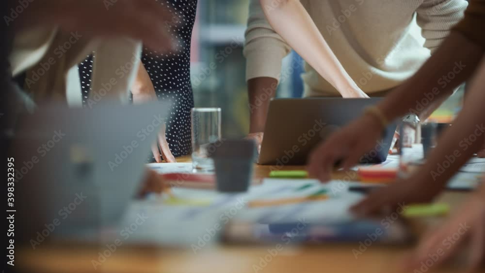 Diverse Multi-Ethnic Team of Professional Businesspeople Meeting in the Modern Office Conference Room. Creative Team Gathers Around Table to Discuss App Design, Analyze Data, Plan Strategy