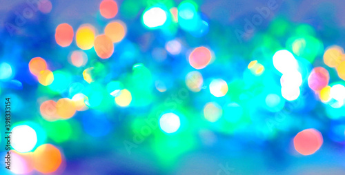 festive background of blurred colorful bright lights.