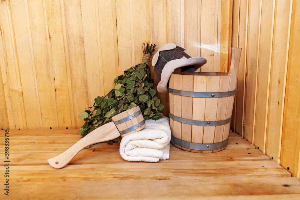 details Finnish sauna steam room with traditional sauna accessories basin birch broom scoop felt hat towel. Traditional old Russian bathhouse SPA Concept. Relax country village bath concept. Stock Photo | Adobe