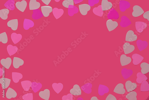 Pink heart shaped confetti on rose packground © Svitlana