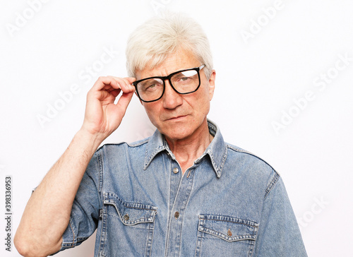 Face of old man wearing eyeglasses over white background