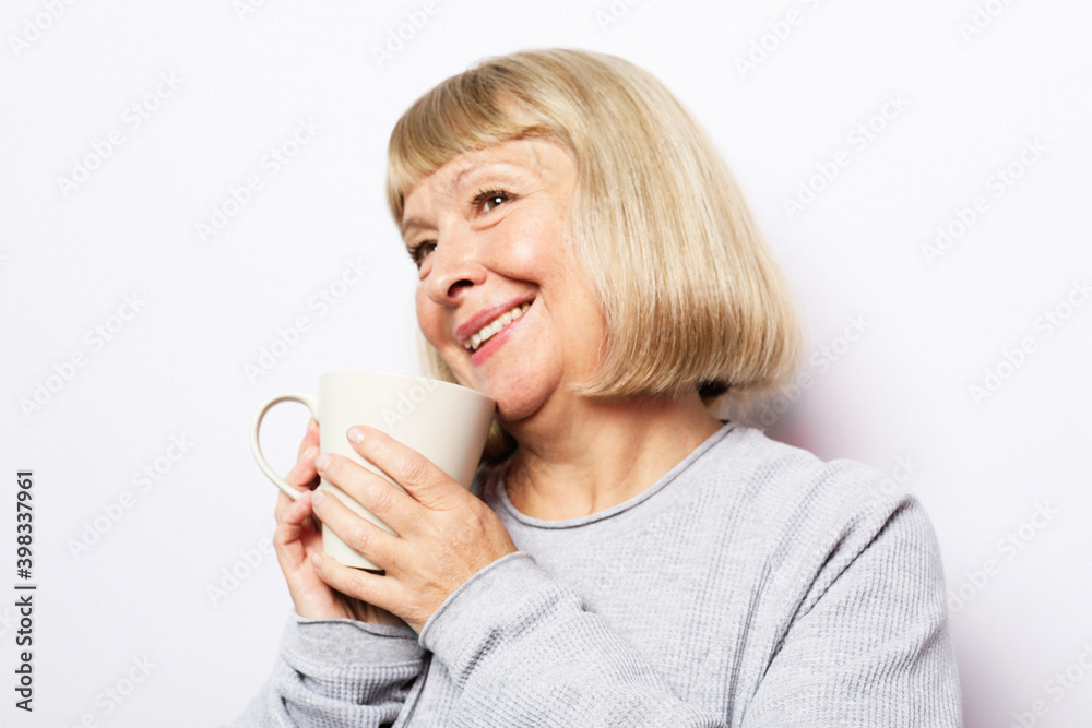 mature woman with short hair, she is enjoying fresh coffee in her hands, mature woman with short hair, she is enjoying fresh coffee in her hands,