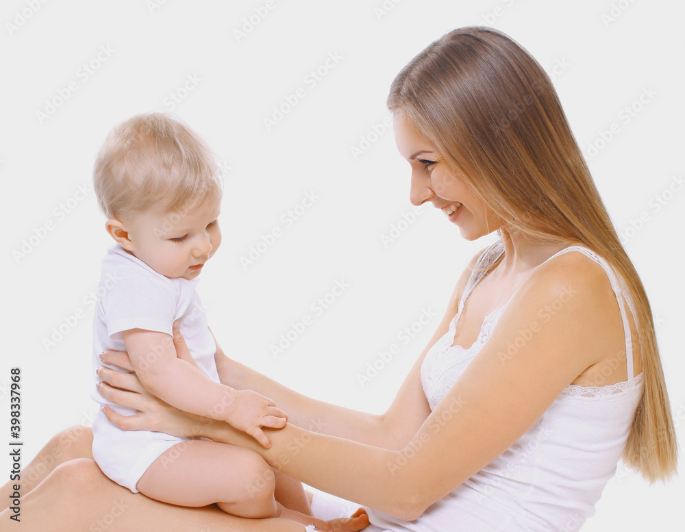 Portrait of cheerful smiling mother and baby playing together over a white background
