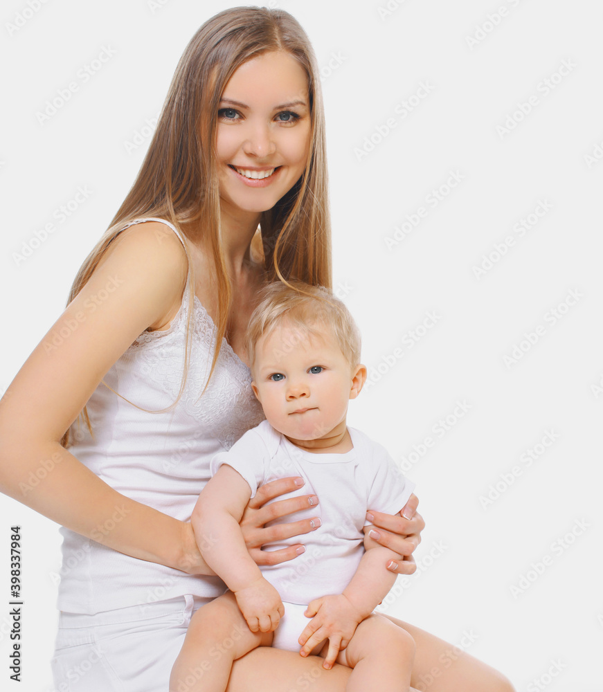 Portrait of cheerful smiling mother and baby playing together over a white background Portrait of cheerful smiling mother and baby playing together over a white background