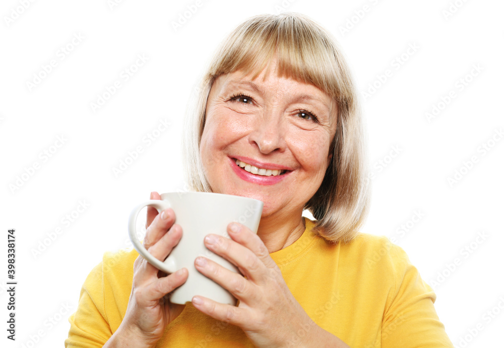 Cheerful elderly woman with cute smile holding a cup isolated on white background Cheerful elderly woman with cute smile holding a cup isolated on white background