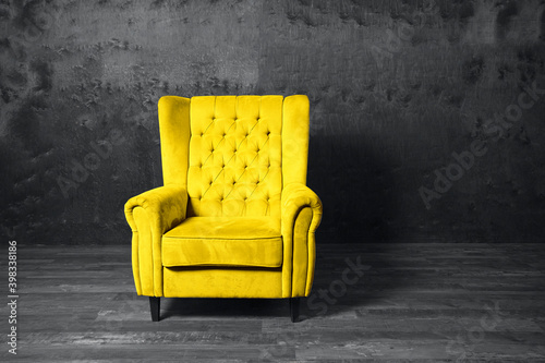 Yellow armchair over grey background. Trendy colors 2021 year. Copy space. 