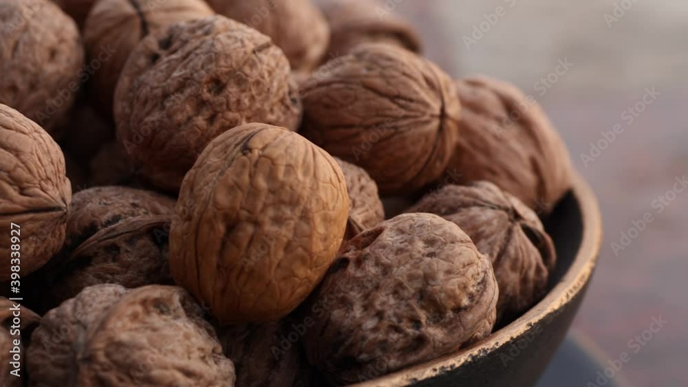Walnuts in a bowl closeup macro outside evening Walnuts in a bowl closeup macro outside evening