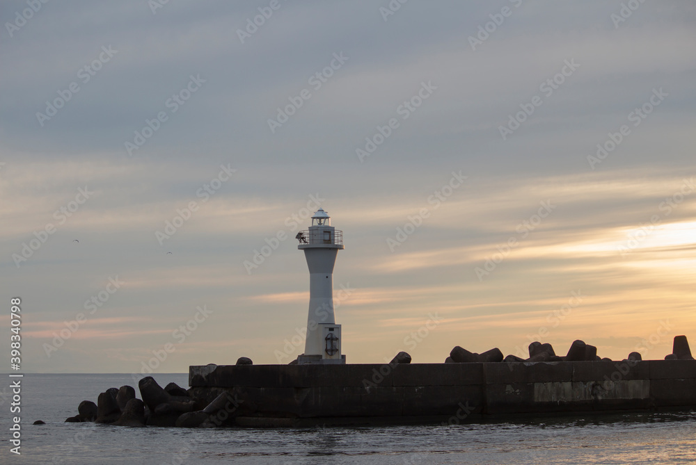 The dim sky at dusk and the lighthouse at Kushiro Port
