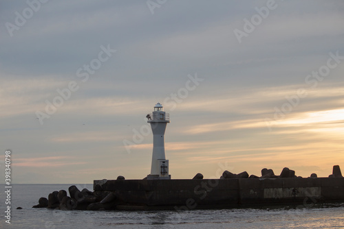 The dim sky at dusk and the lighthouse at Kushiro Port