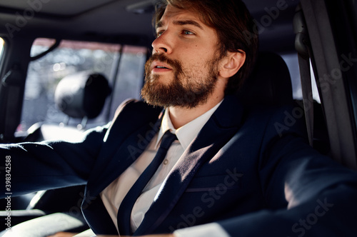 successful young man driving a car in a suit trip lifestyle © SHOTPRIME STUDIO