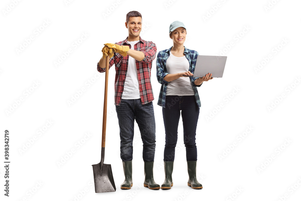 Full length portrait of modern farmers, male and female with a laptop computer - obrazy, fototapety, plakaty 