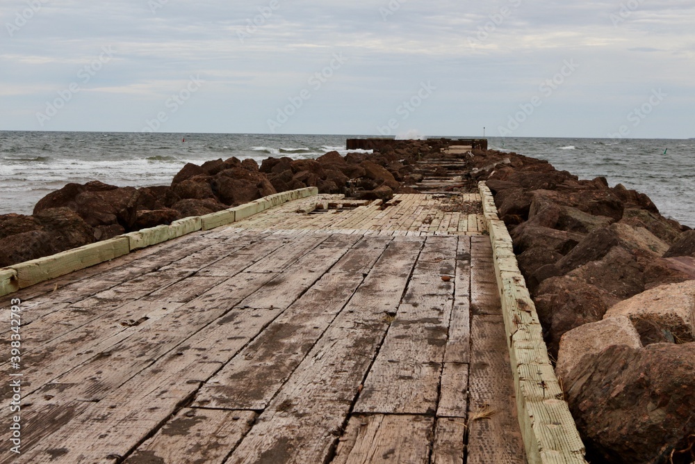 An old pier leads out into the Atlantic Ocean in North Rustico, PEI. 