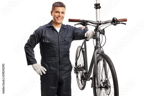 SMiling repairman with a bicycle on a stand