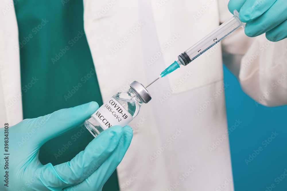 doctor hand with coronavirus vaccine and injection or syringe doctor hand with coronavirus vaccine and injection or syringe